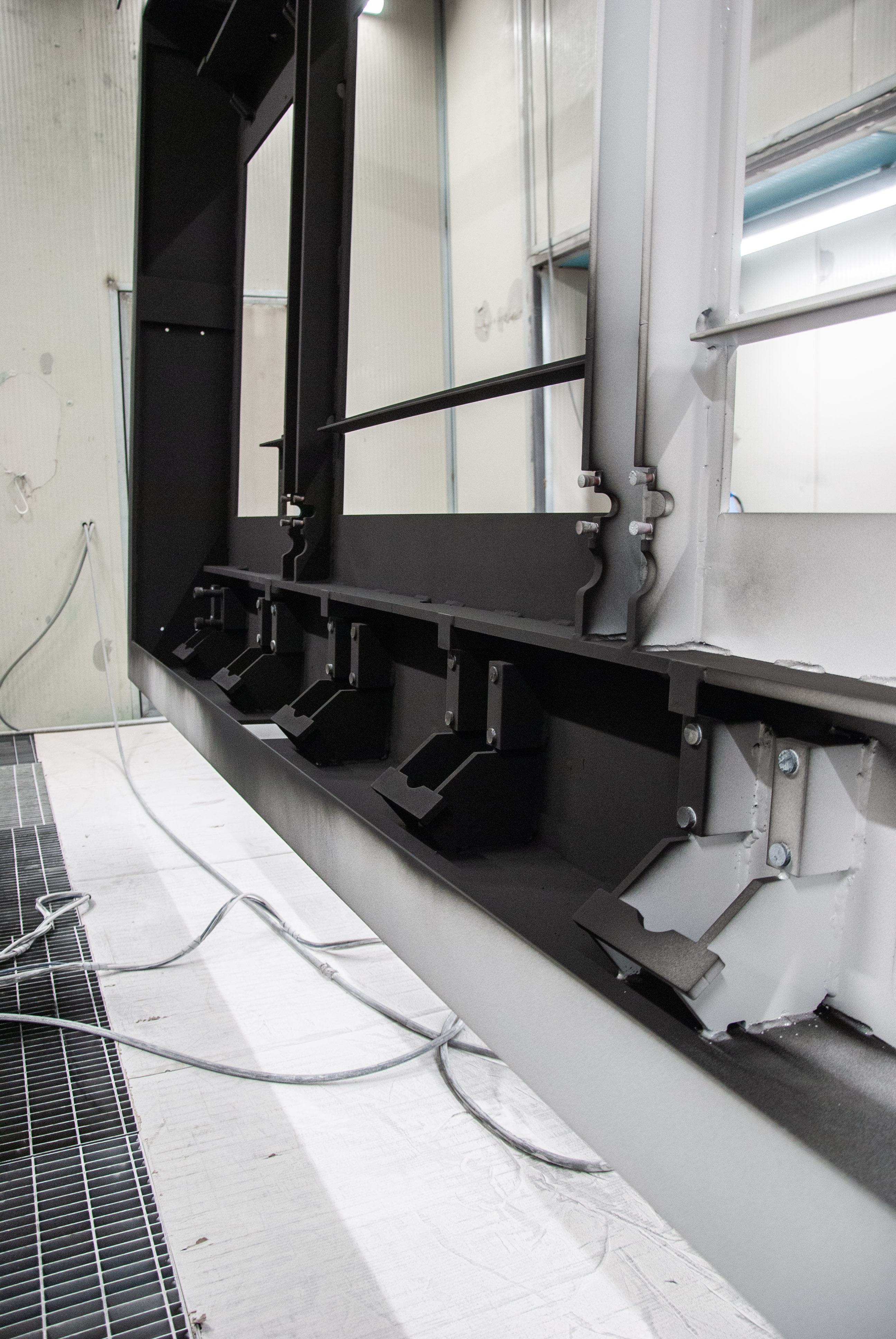 Image of primer coating process on the frame of a road blocker 
